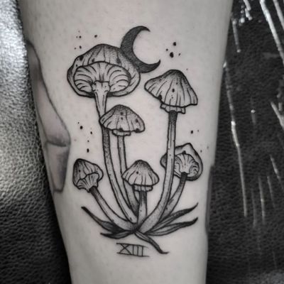 Experience the magic with this black and gray tattoo by Elisa Thirteen, featuring moon, mushroom, roman numerals, and shrooms. Perfect for small lettering lovers.