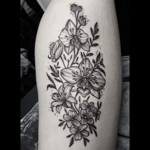 Elegant black and gray dotwork floral tattoo on the arm by renowned artist Elisa Thirteen