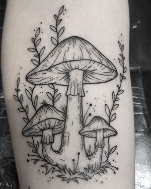 This captivating black and gray mushroom tattoo on the forearm is a masterpiece by the talented artist Elisa Thirteen.