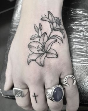 Elegant flower design created by Elisa Thirteen, perfect for a hand tattoo. Black & gray style adds depth and sophistication.
