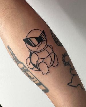 Get inked with this cool Squirtle forearm tattoo in anime style by the talented Miss Vampira. Embrace your love for Pokémon!