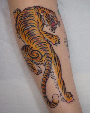 Impressive traditional Japanese tiger tattoo on forearm by artist Alex Travers. Powerful and fierce design.