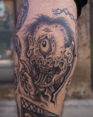 Get a striking Japanese-inspired oni eye tattoo on your lower leg by artist Alex Travers. A unique blend of traditional and modern styles!