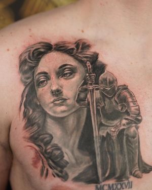 A powerful black and gray micro-realism chest tattoo by Soheyl Astangi featuring a knight, a sword, and a woman's portrait.