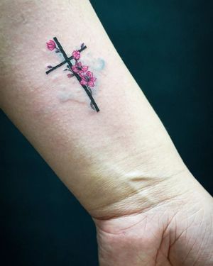 Elegant and delicate fine line design by Soheyl Astangi featuring a beautiful flower and cross motif. Perfect for those seeking a meaningful and artistic tattoo.