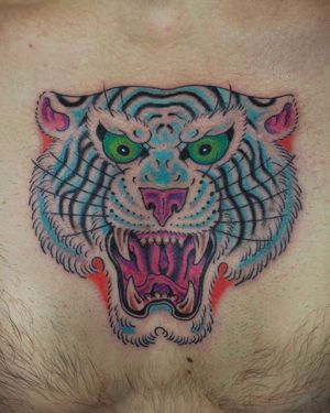Bold tiger tattoo by Alex Travers fusing Japanese and neo-traditional styles on stomach.