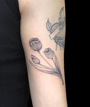 Adorn your forearm with Misa's stunning black and gray floral masterpiece featuring delicate tulips.