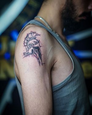 Impressive black and gray design featuring a knight's helmet with intricate lines, expertly done by Soheyl Astangi on the upper arm.