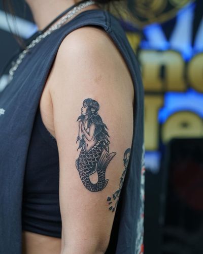 Traditional tattoo of a beautiful mermaid girl on the upper arm, created by Soheyl Astangi.