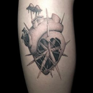 Get inked with a beautiful black and gray heart and pattern tattoo expertly done by Misa on your lower leg. Stand out from the crowd with this unique design!
