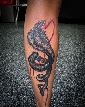 Explore the intricate beauty of this black and gray ornamental tattoo featuring a snake with flickering tongue, by artist Soheyl Astangi.