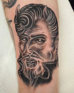 Get inked with a sinister devil horn design on your forearm by the talented artist Alex Travers. Embrace your dark side in style!