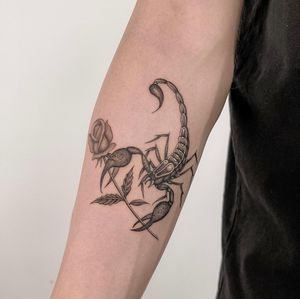 Unique black and gray, dotwork, and fine line forearm tattoo featuring a scorpion and flower design by Federico Tronconi.