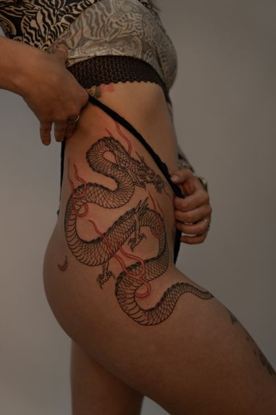 A stunning Japanese dragon tattoo on the hip, expertly crafted by artist Federico Tronconi. Embrace the power and beauty of this mythical creature.