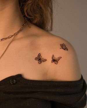 Elegant butterfly design on shoulder by Federico Tronconi, featuring intricate fine line work.