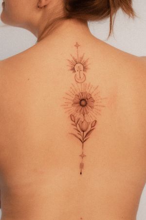 Fine line tattoo on the back featuring a delicate moon and flower design by Federico Tronconi.