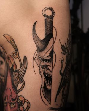 Stunning black and gray design by Jacky Yang, featuring a dagger and menacing hannya eye. Perfect for upper leg placement.