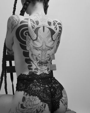 Experience the haunting beauty of a traditional Japanese hannya mask tattoo expertly crafted by Federico Tronconi on your back.