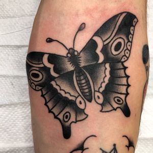 Get a timeless traditional tattoo of a moth done by renowned artist Claudia Trash. Perfect for vintage ink lovers!