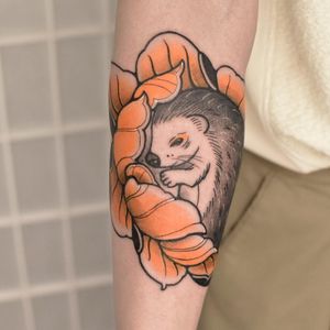 Vibrant neo-traditional tattoo featuring a beautiful flower and adorable ferret design, expertly created by Jacky Yang.