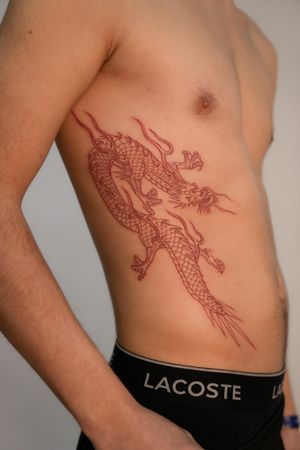Get an intricate Japanese dragon tattoo on your ribs by renowned artist Federico Tronconi. Dazzle in tradition and mythology.