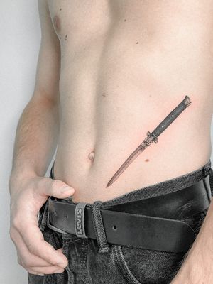 Check out this stunning knife tattoo by Federico Tronconi, blending fine line work and realism on the stomach.