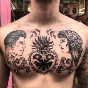 Classic and bold traditional heart tattoo design on the chest by talented artist Claudia Trash.