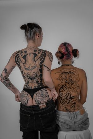 Stunning Japanese back tattoo featuring a fierce tiger and symbolic henya, done by Federico Tronconi.