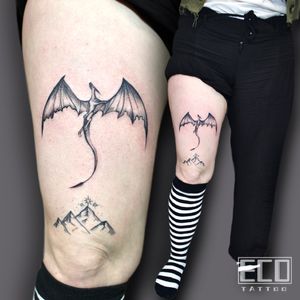 Experience the power and mystique of a dragon with this striking black and gray tattoo on your upper leg. Designed by Lin Feng for a unique and captivating look.