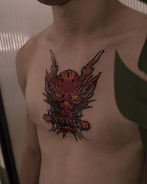 Get inked with a stunning Japanese-inspired red dragon tattoo on your chest by the talented artist Jacky Yang.