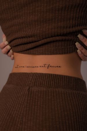Elegantly crafted fine line tattoo on the back featuring a meaningful quote by Federico Tronconi. Perfect blend of style and sophistication.