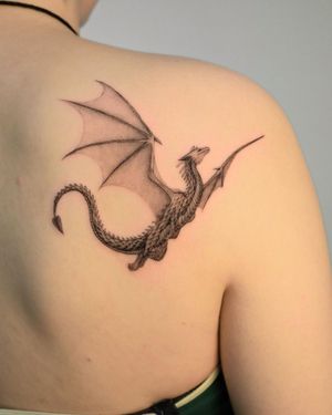 Exquisite black and gray dragon tattoo by Federico Tronconi, delicately inked on the upper back for a mystical touch.