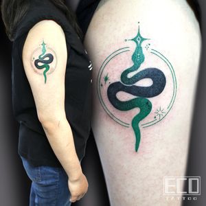 Vibrant new school snake design on the upper arm by the talented artist Lin Feng. Stand out with this eye-catching tattoo!