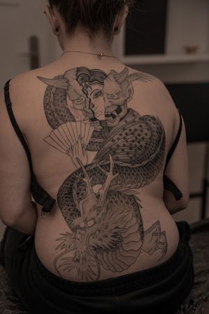 Experience the mystical beauty of a Japanese dragon and hannya mask in this stunning back piece by Federico Tronconi.