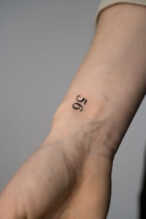 Get a stylish number tattoo in small lettering on your wrist by the talented artist Federico Tronconi.