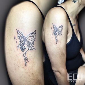 Capture the magic with this exquisite fine line tattoo of a fairy surrounded by stars on your upper arm. Created by Lin Feng.