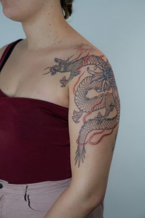 Experience the artistry of Federico Tronconi with this majestic Japanese dragon tattoo, perfect for your upper arm. Embrace the timeless tradition of Japanese tattooing.