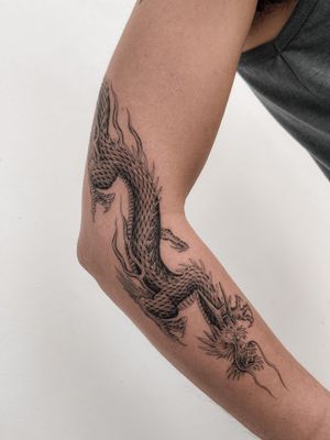 Embrace the power and elegance of a traditional Japanese dragon tattoo, expertly crafted by Federico Tronconi on your arm.