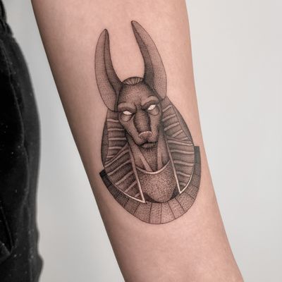 Unique dotwork tattoo by Federico Tronconi on forearm. Blend of traditional and modern styles, featuring a dog and Anubis motif. 