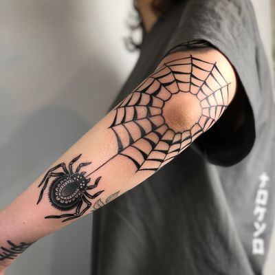 Unique and intricate blackwork spider tattoo on forearm by talented artist Claudia Trash.