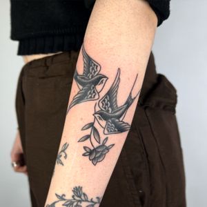 A stunning fine line traditional bird tattoo on the forearm, expertly done by the talented artist Claudia Trash.