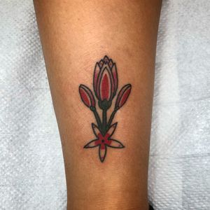 Get a stunning traditional flower tattoo on your lower leg by the talented artist Claudia Trash. Embrace the beauty of nature with this timeless design.