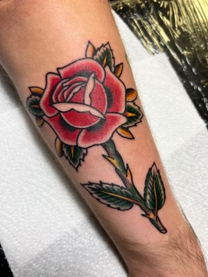 Get a beautiful traditional flower tattoo by renowned artist Claudia Trash on your forearm.