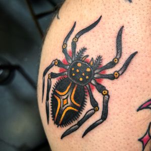 Get a classic spider design on your knee by the talented artist, Claudia Trash. Perfect for fans of traditional tattoos!