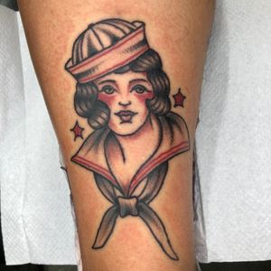 Traditional style forearm tattoo featuring a nurse motif, expertly done by Claudia Trash.