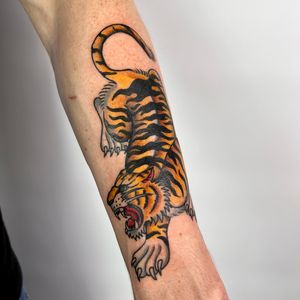Check out this fierce tiger design by Claudia Trash, perfect for your forearm in a traditional Japanese style.