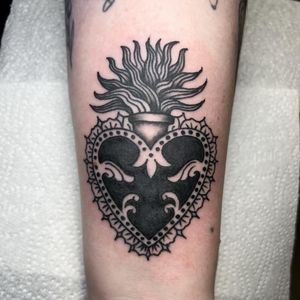 Show off your love with this traditional blackwork heart and filigree tattoo by Claudia Trash on your forearm.