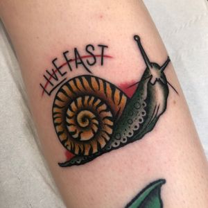 Unique upper arm tattoo with a whimsical snail motif and inspiring quote by Claudia Trash. Perfect blend of style and message.