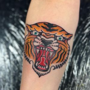 Experience the fierce beauty of a traditional tiger motif tattoo on your forearm, expertly done by the talented artist Claudia Trash.