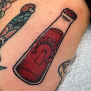 Get a splash of color and motivation with this new school bottle and quote tattoo on your arm. Designed by the talented artist Claudia Trash.